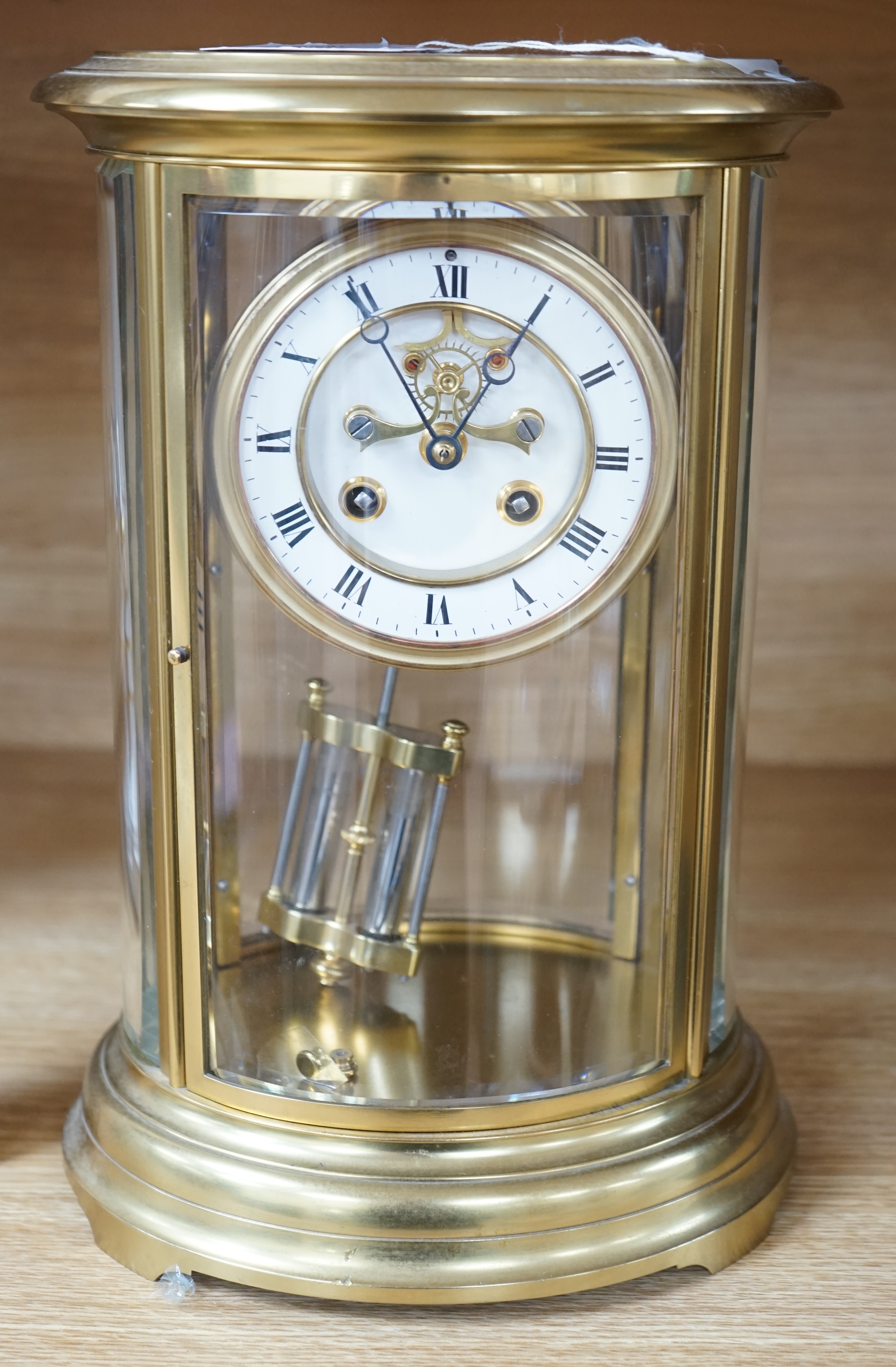 A 19th century French gilt brass oval four glass mantel clock with Brocot escapement, 30cm high. Condition - good